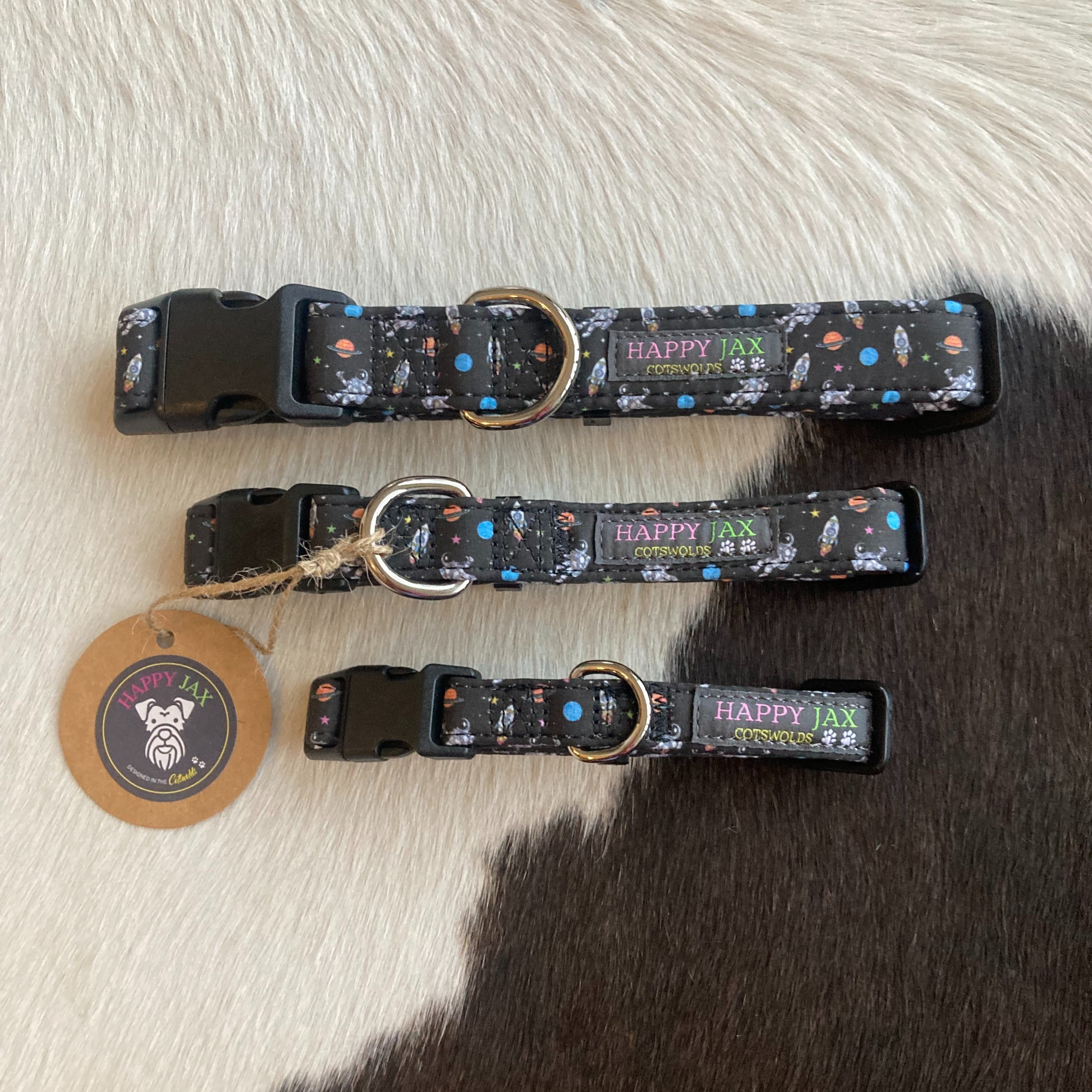 3 collars patterned with astronauts and rocket ships surrounded by colourful planets and stars on a black background designed in the Cotswolds