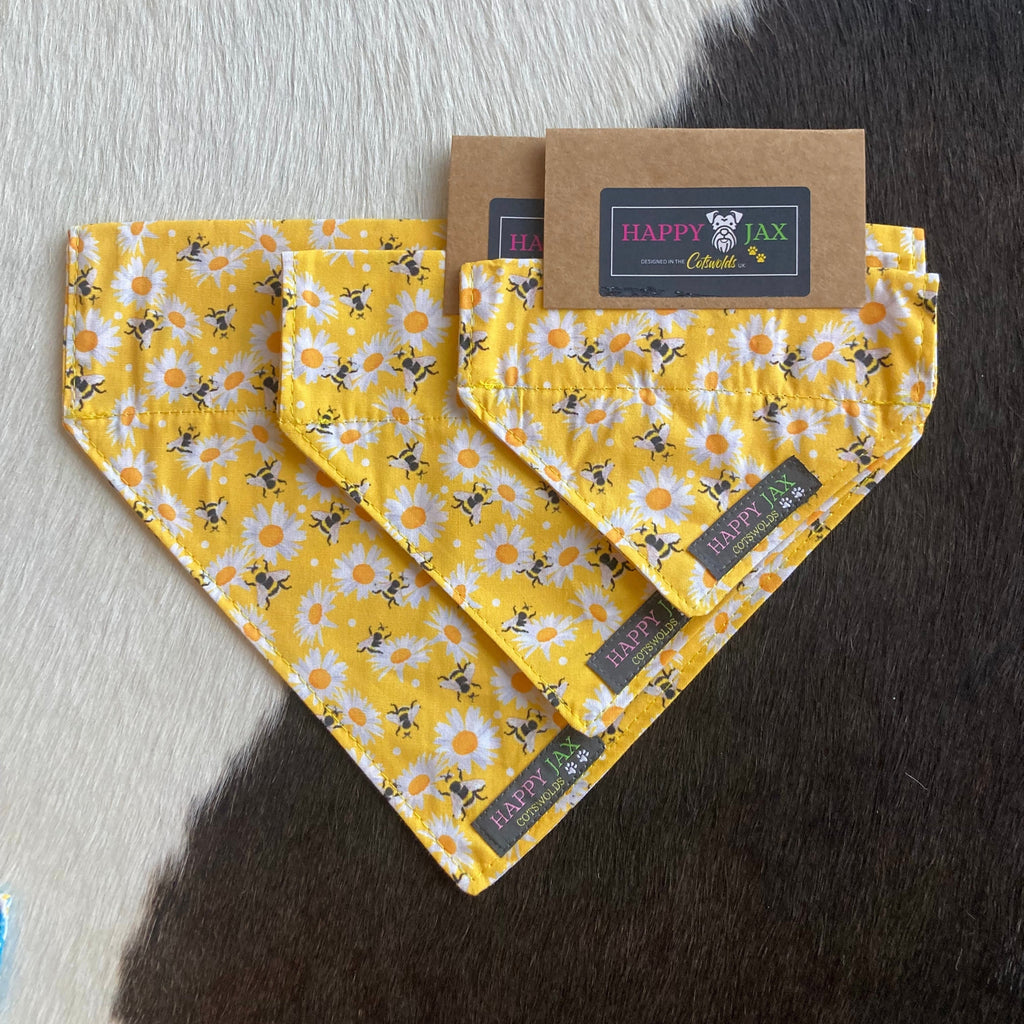 3 different sizes of bandanas with a pattern of honey bees and daisies on a bright yellow background suitable for our cat and dog collars