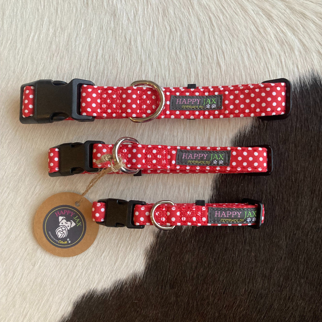3 animal collars of differing sizes with a white polka dot pattern on a red background